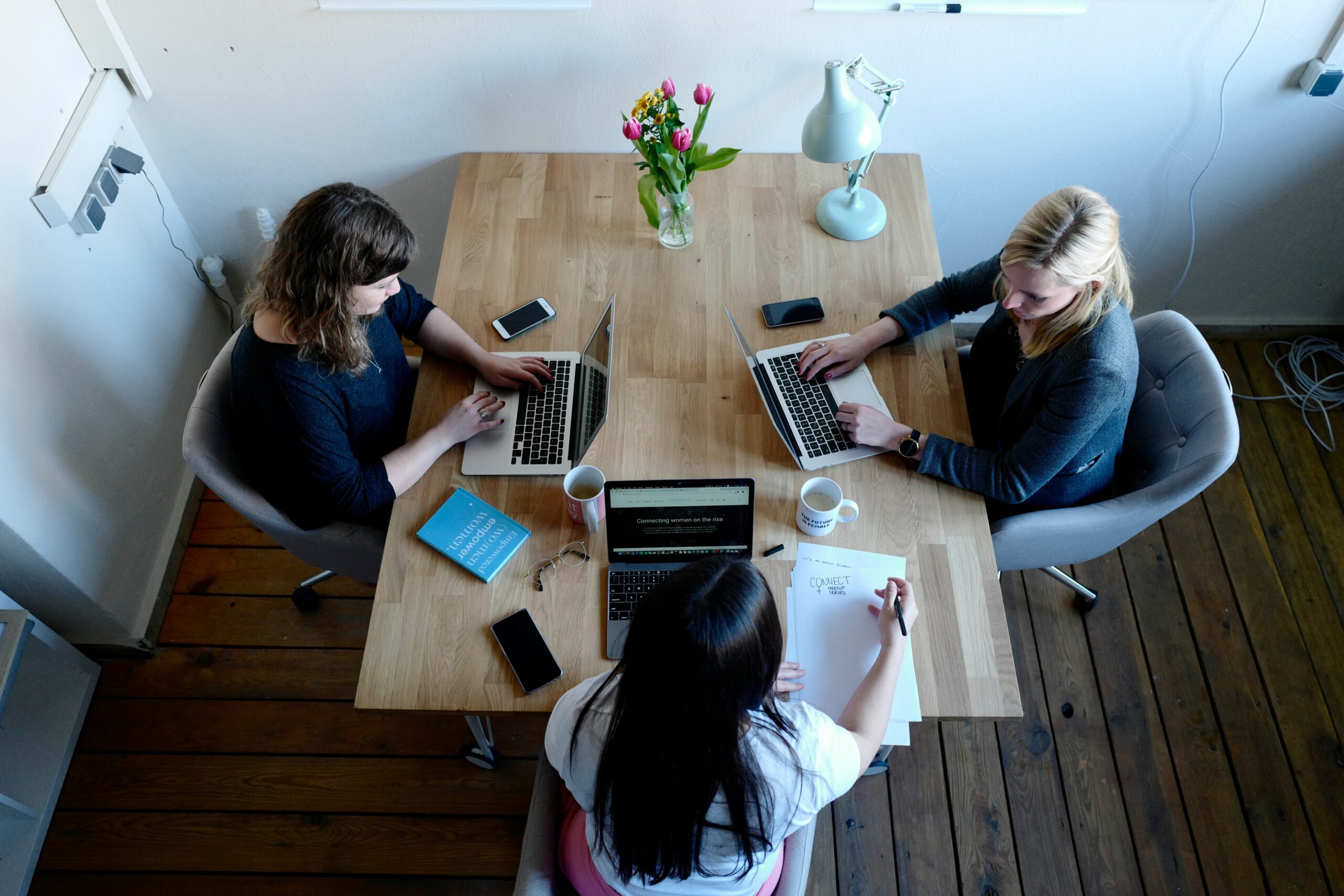 Medium enterprise business team collaborating on growth strategies using digital tools and analytics in a modern office setting.