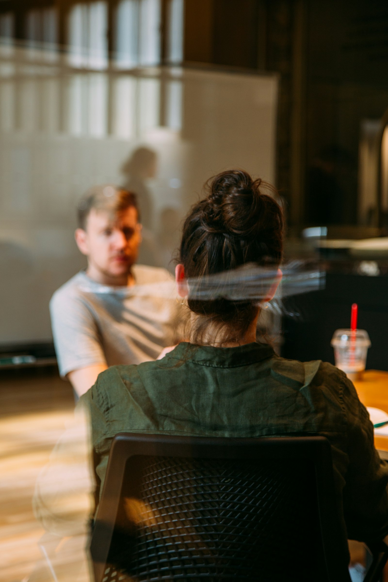 A leadership consultant in conversation with a business leader during a coaching session