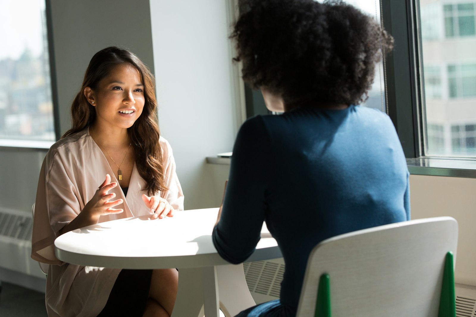Manager giving constructive feedback to an employee in a one-on-one conversation