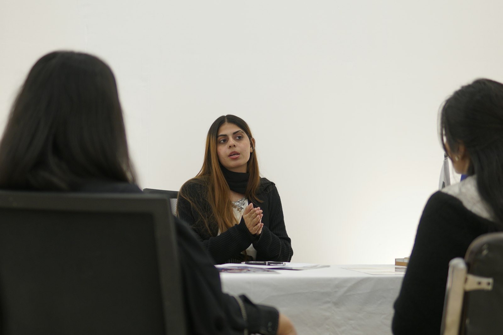 A team member speaking openly and confidently to colleagues in a meeting